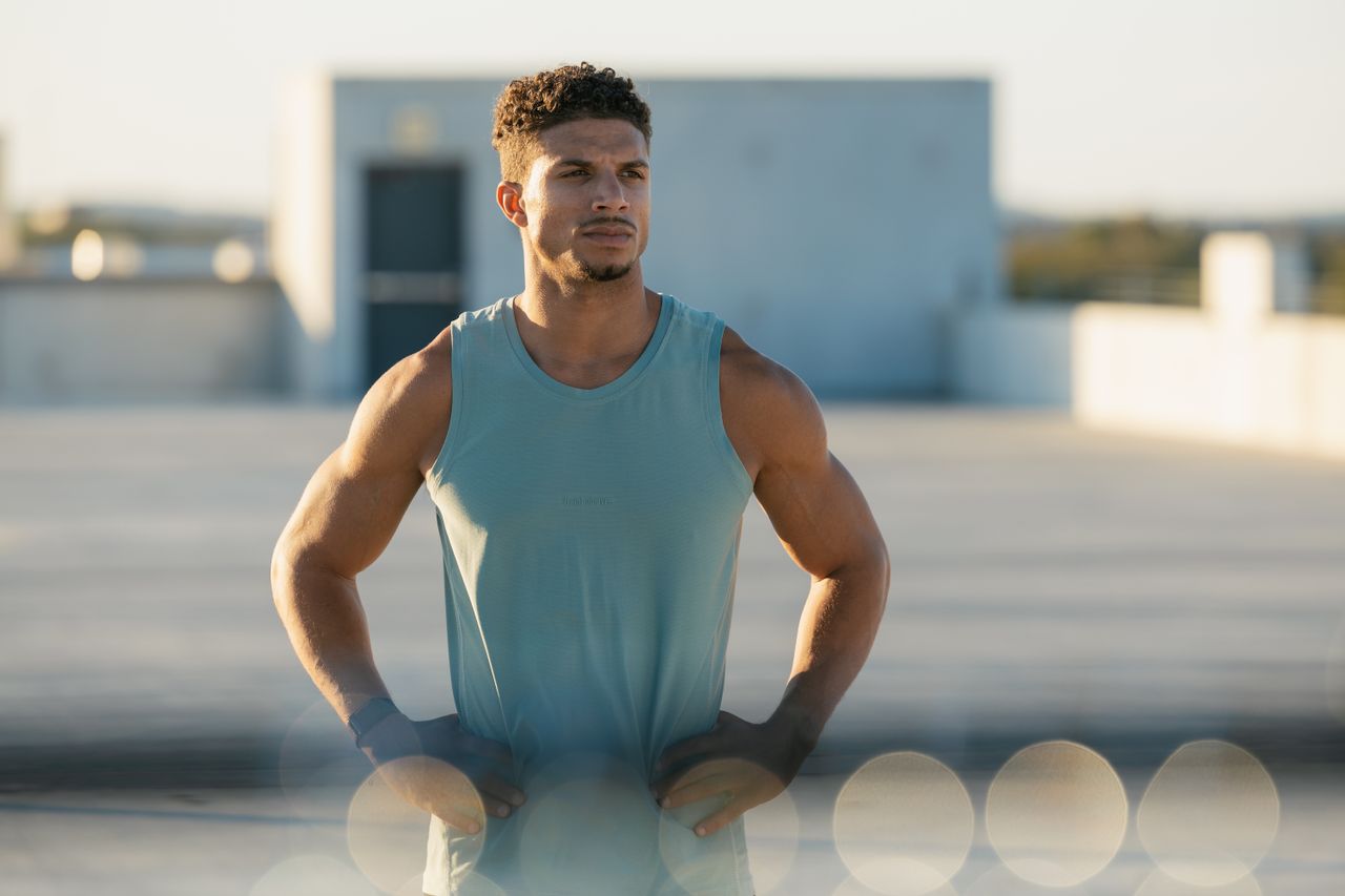 Fit man in casual workout attire on a city rooftop, Austin, Texas.
