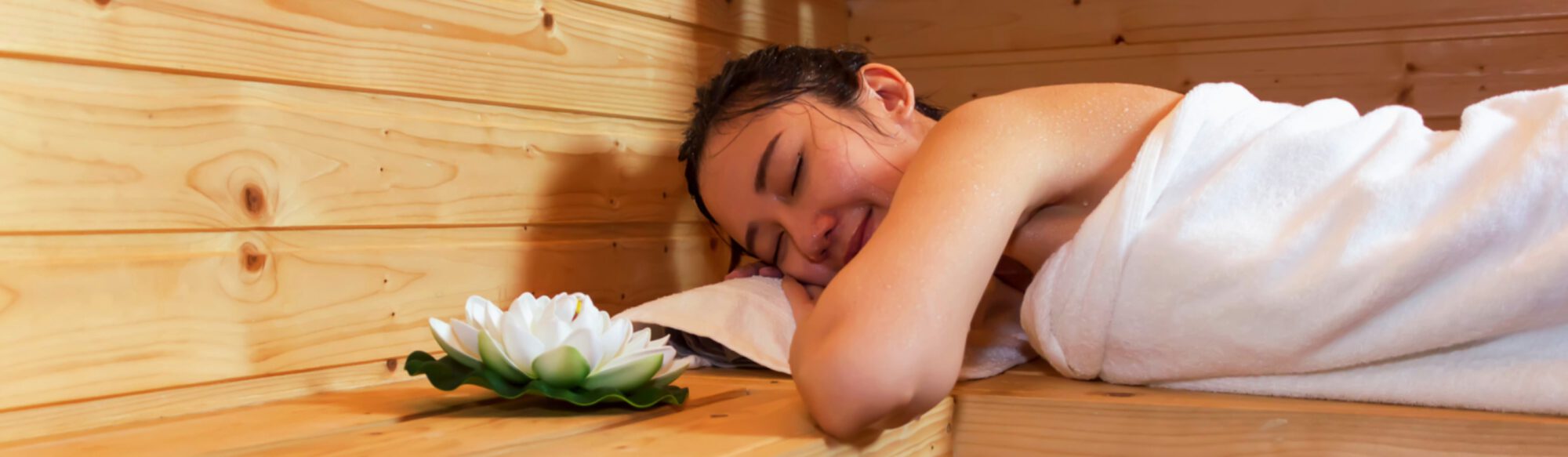 Relaxing woman in a sauna